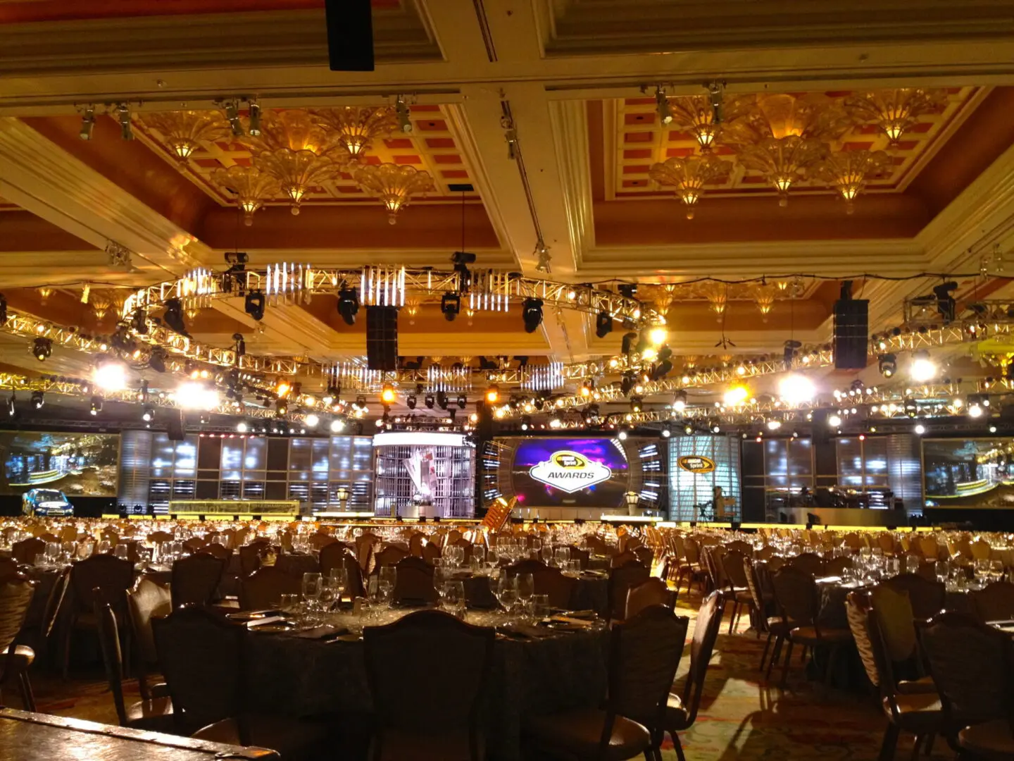 Elegant banquet hall set up for a grand event with warm lighting.