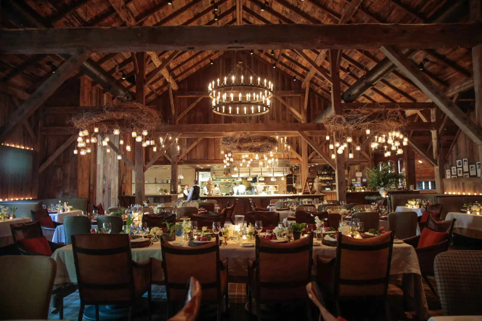 Elegant rustic dining room with warm lighting and wooden beams.
