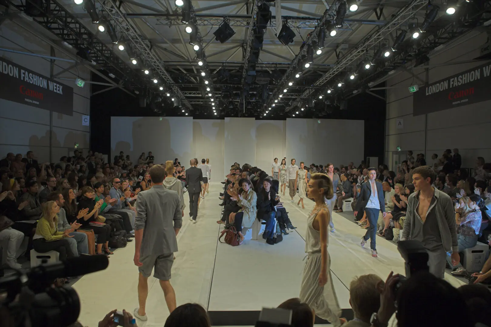 Models walking down a runway during a fashion show.