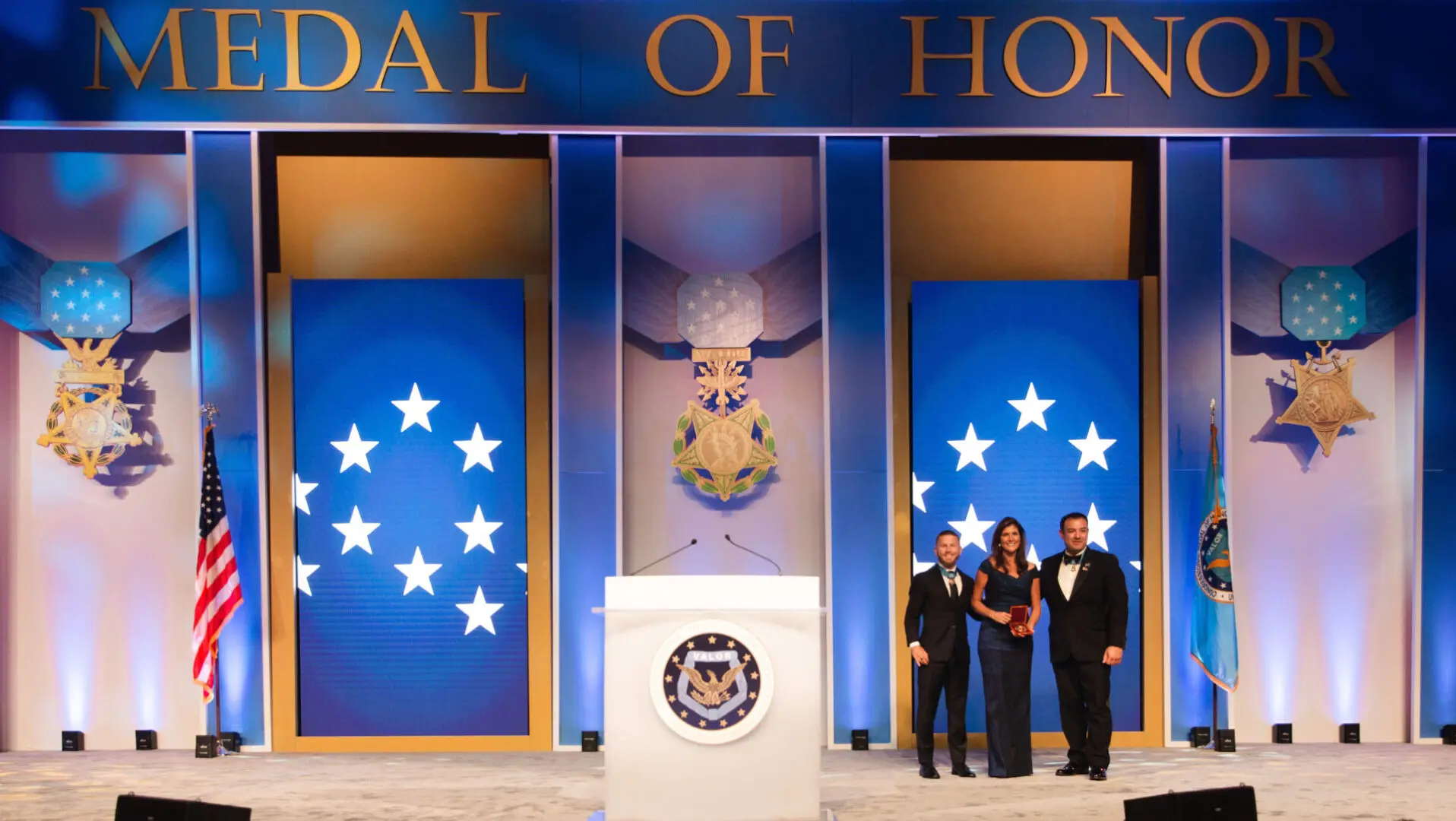 Medal of Honor ceremony with recipients on stage.