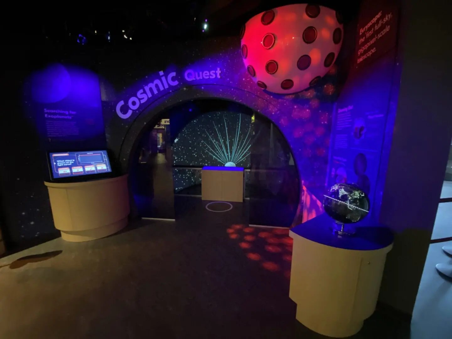 A colorful cosmic-themed exhibit with glowing lights and interactive displays.