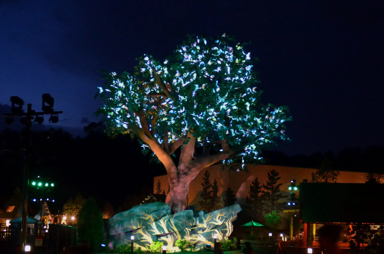 A tree adorned with glowing blue lights at night.