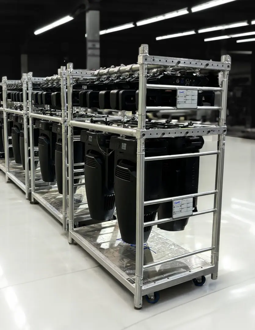 Metal rack holding multiple computer cases in a warehouse.
