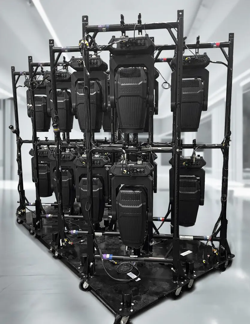 Black camera bags organized on a metal rack in a studio.