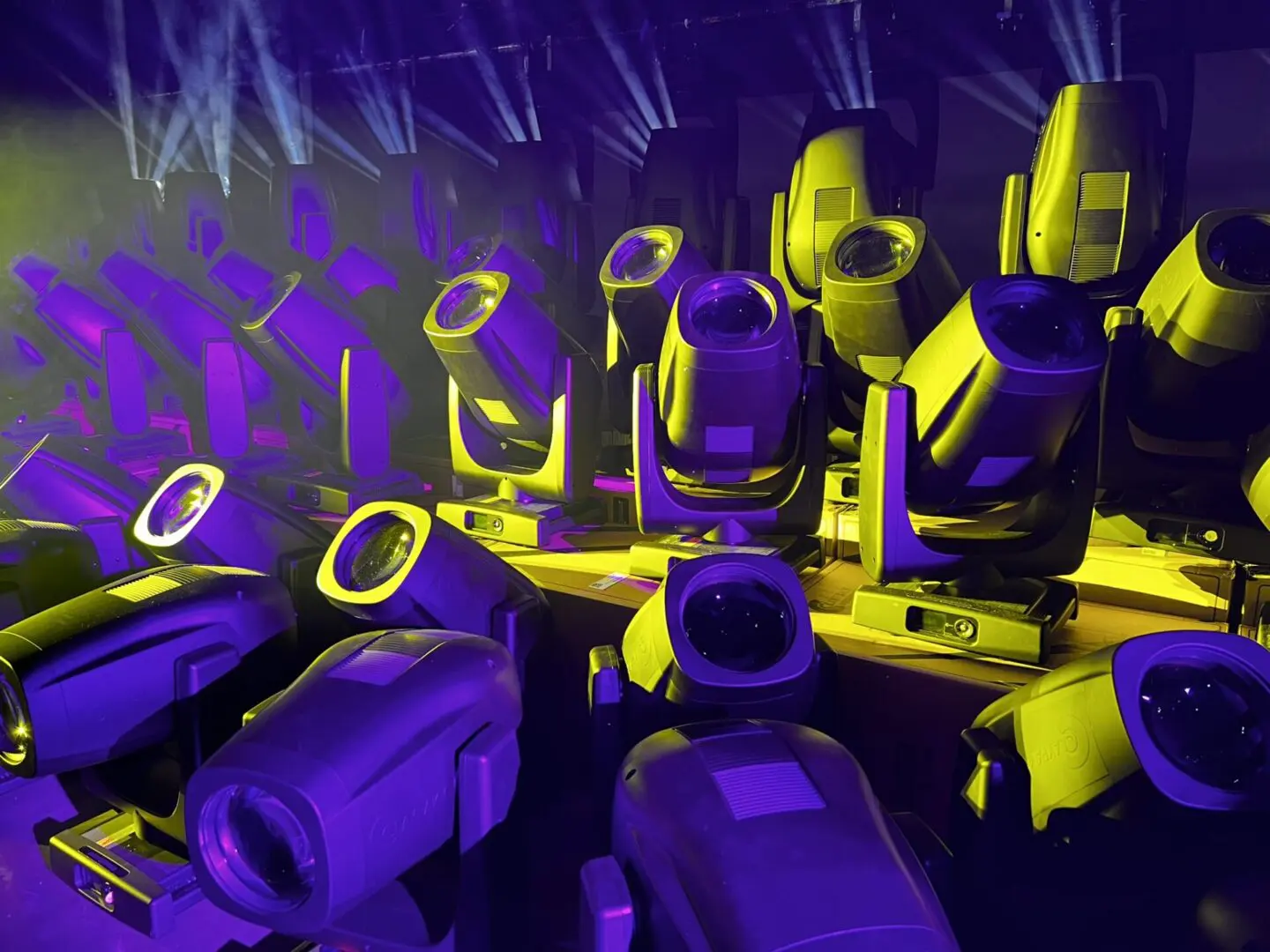 Stage lighting equipment with yellow and purple lights.