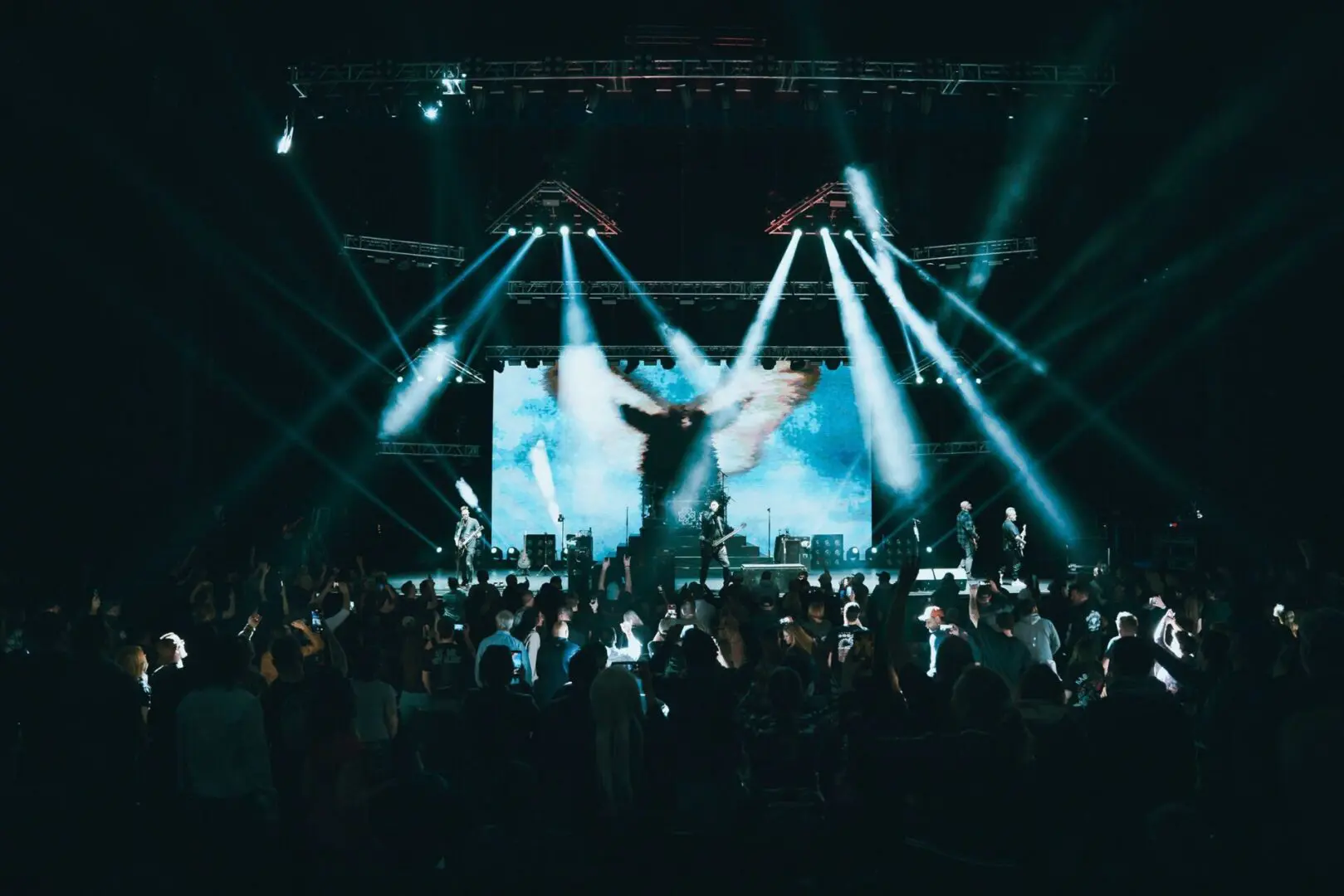 Performer energizes a packed concert with dynamic stage lighting.