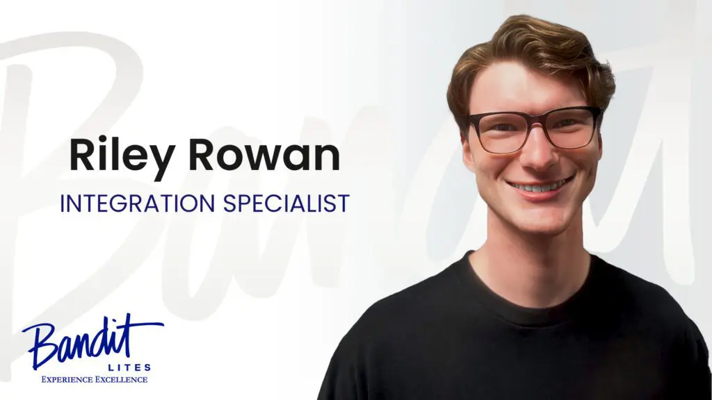 Portrait of a smiling young man with glasses, labeled as an education specialist.