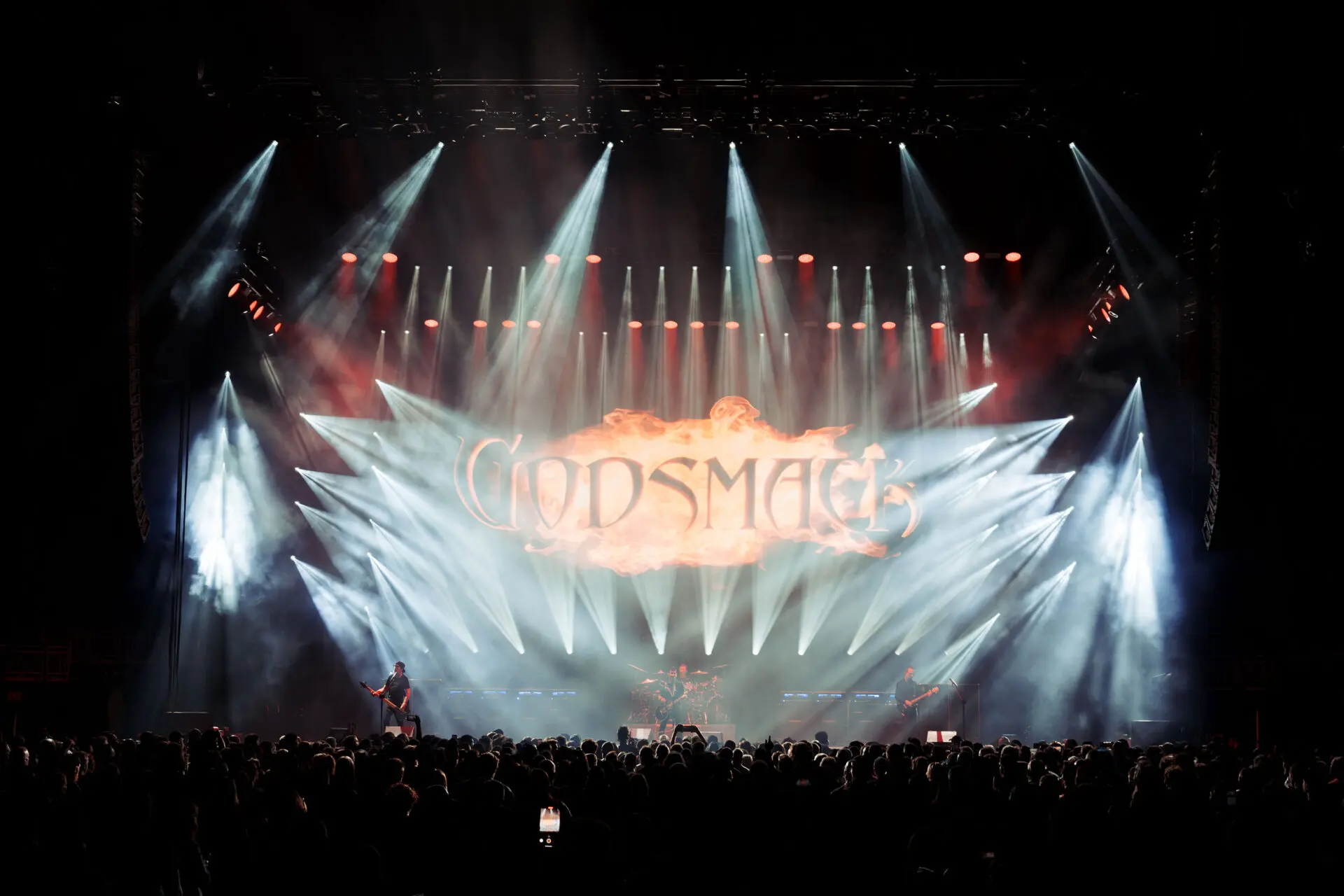 A concert stage with dramatic lighting and the word "Godsmack" displayed.