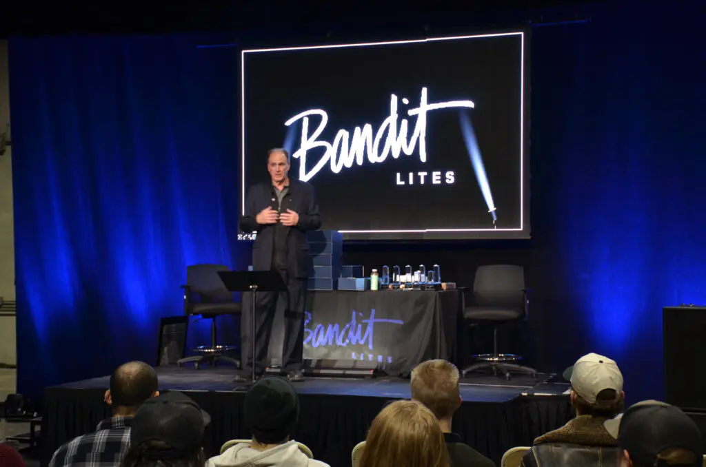 A speaker presenting at a Bandit Lites event on stage.