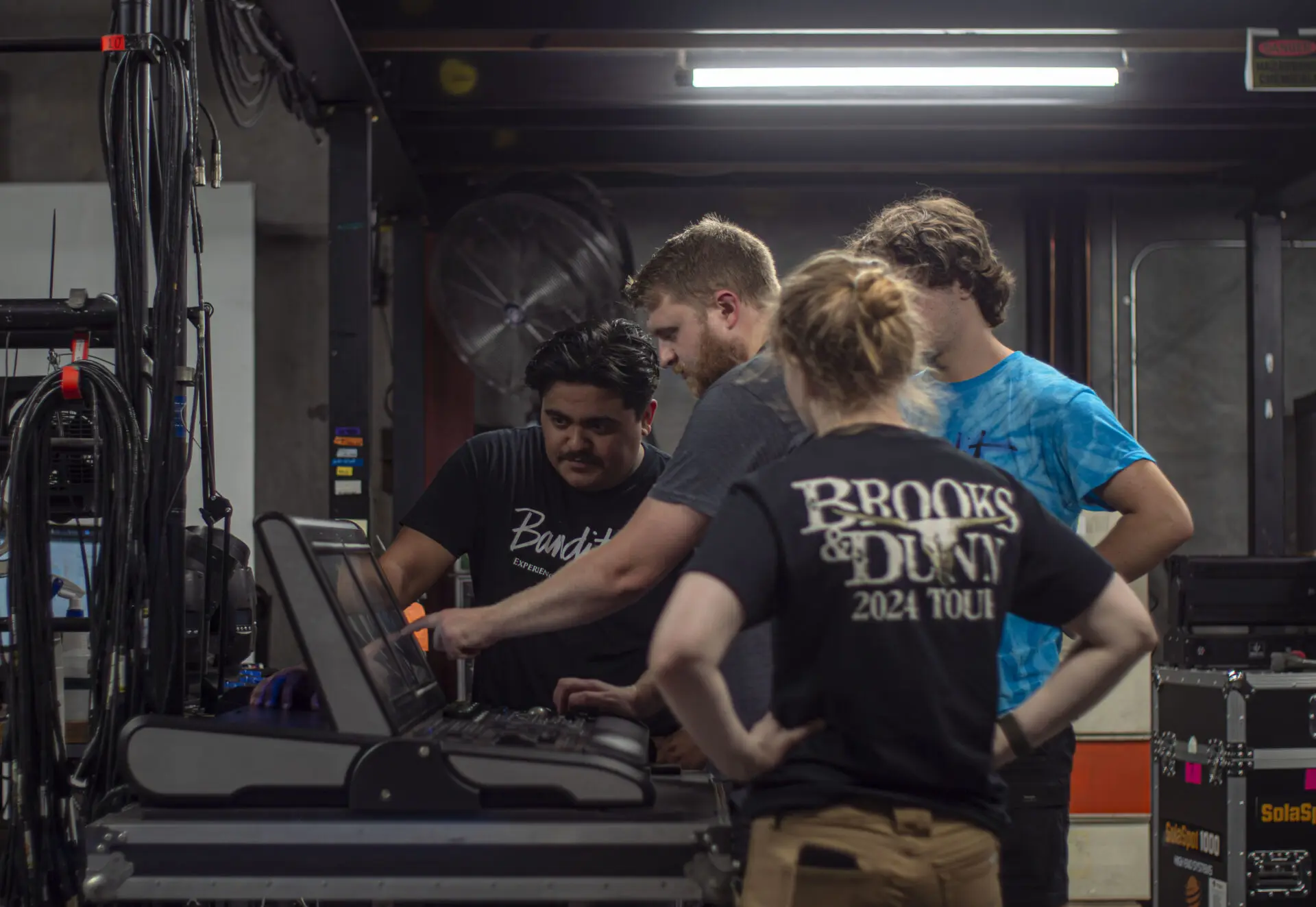 A group of young adults working together on a project indoors.