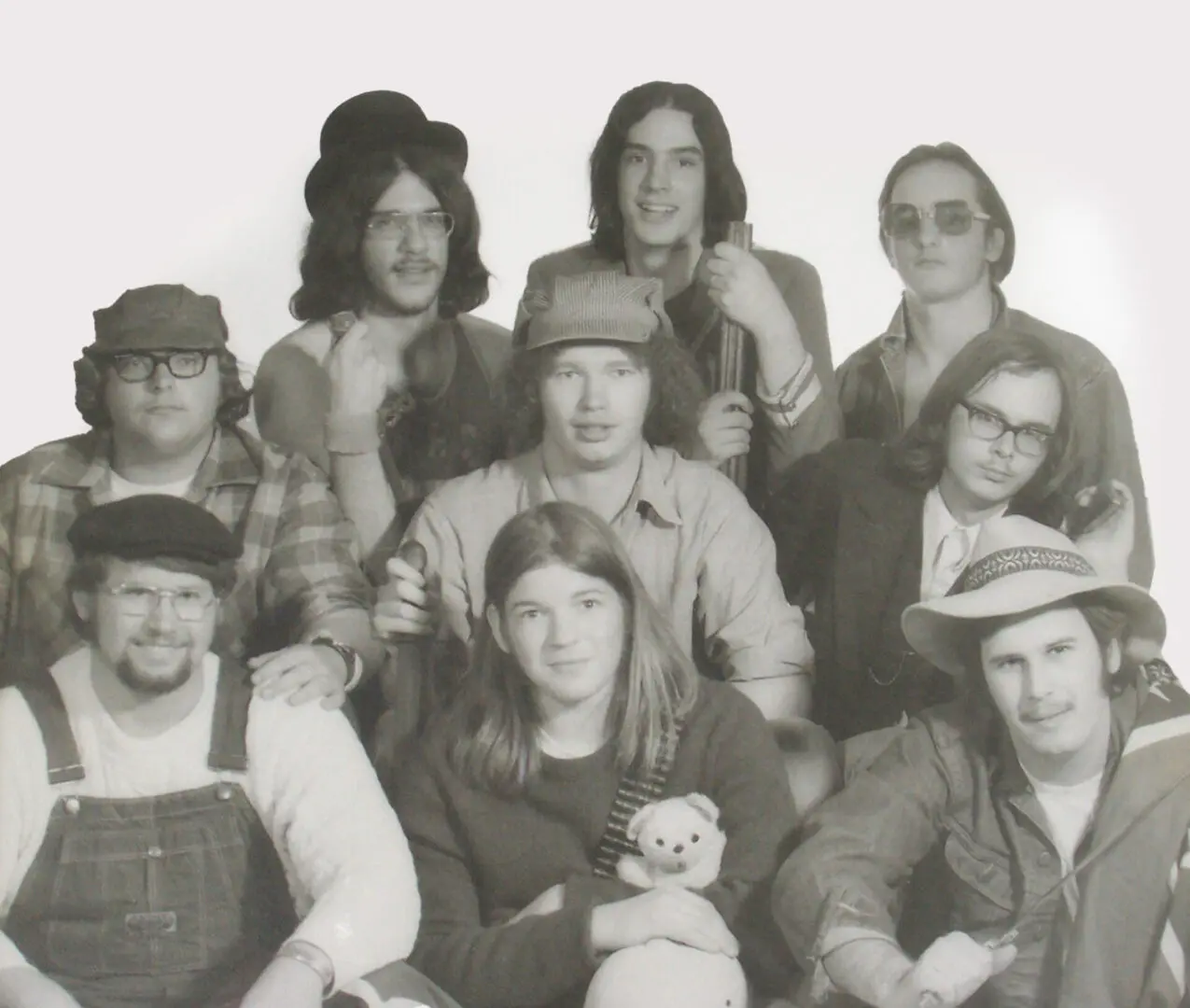 Black-and-white group photo of actors in vintage costumes.