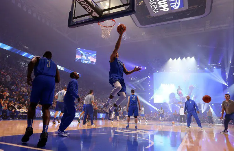 A basketball player jumps to dunk the ball during a game.