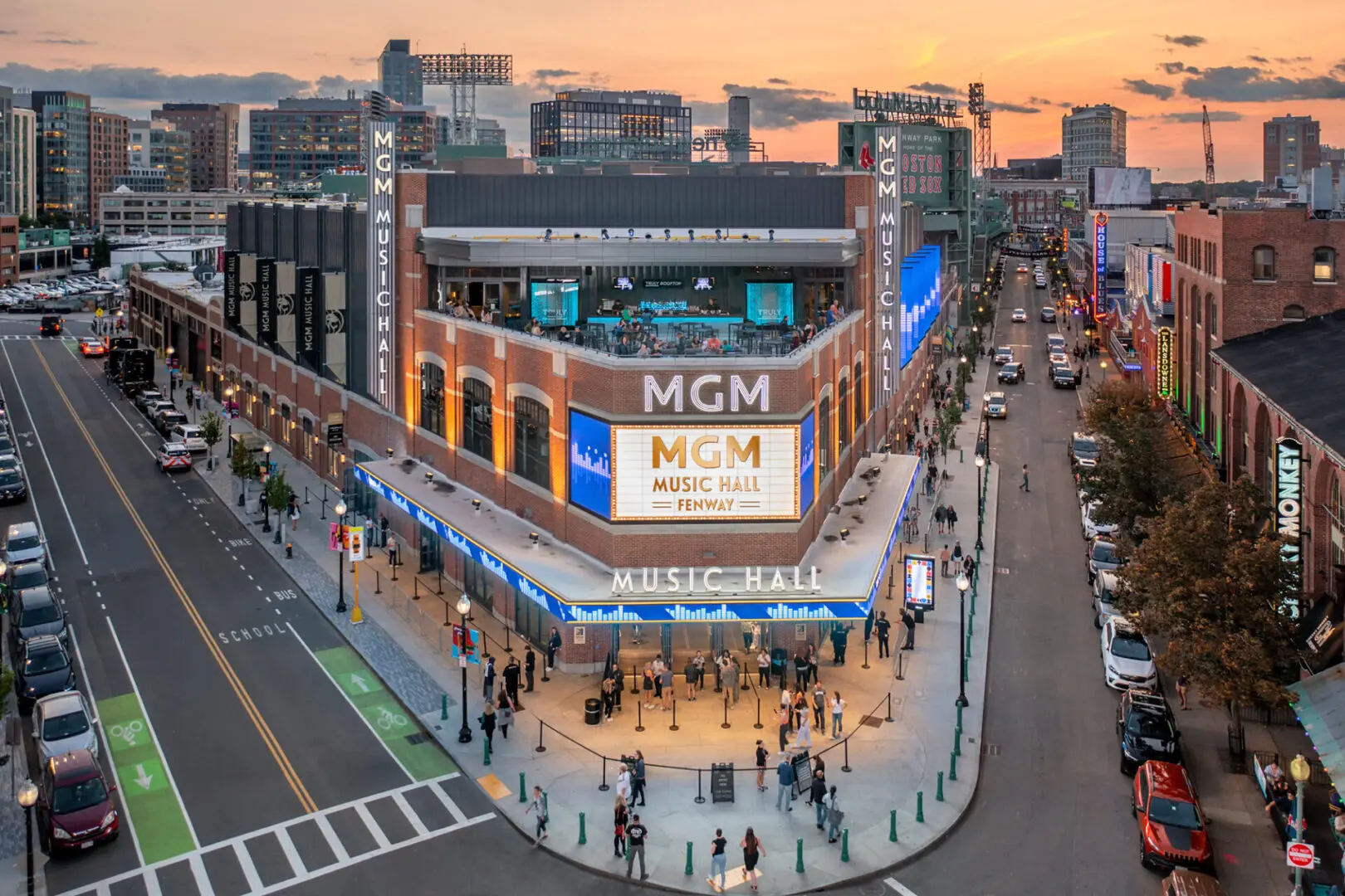 MCM store at sunset on a bustling city street corner.