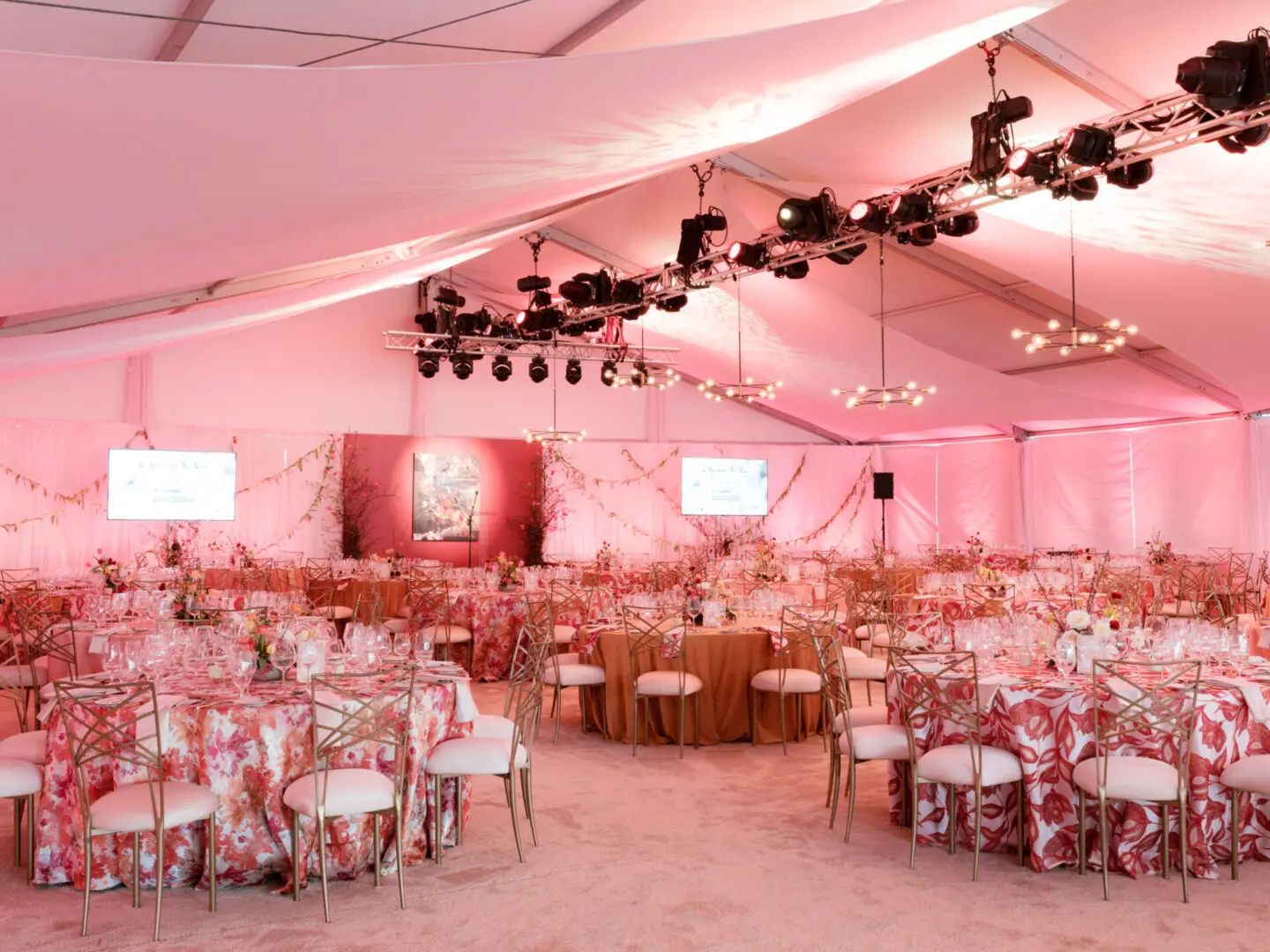 Elegant wedding reception setup with floral decorations and soft lighting.