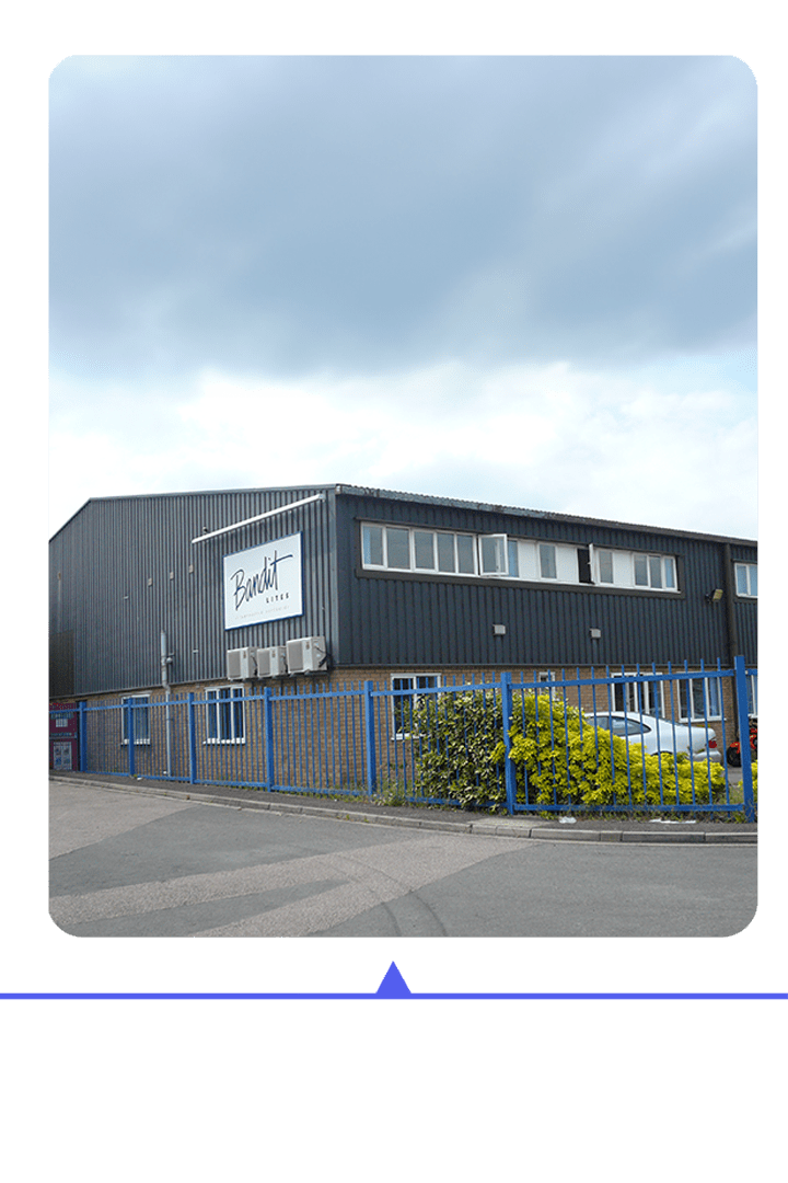 Modern industrial building with a fenced perimeter and clear signage.