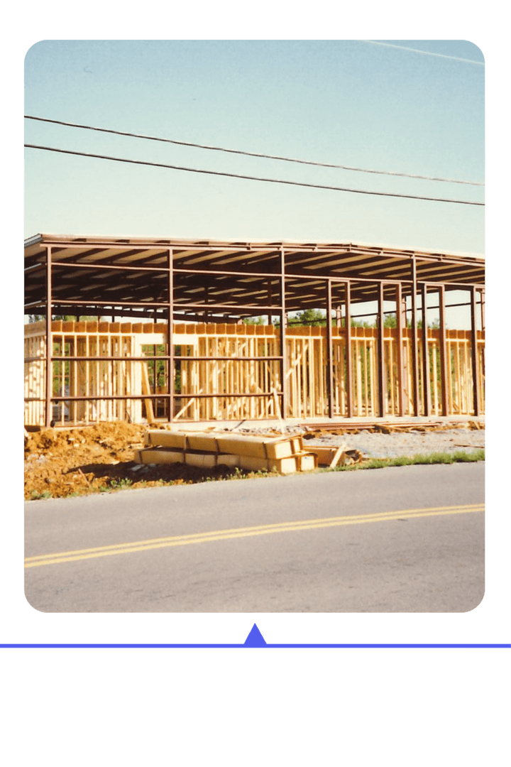 Construction site with wooden framing of a building in progress.