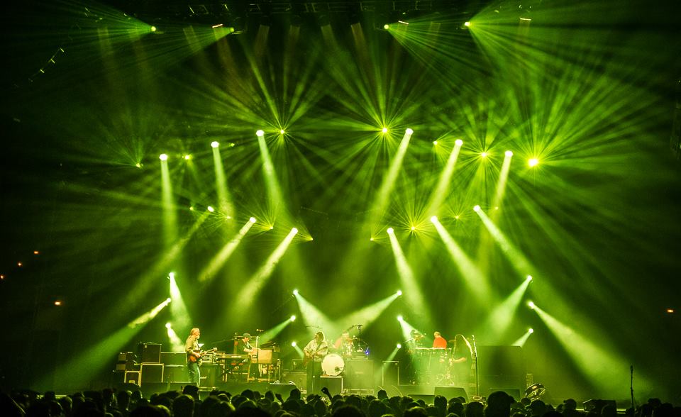 Live band performance with vibrant green stage lighting.