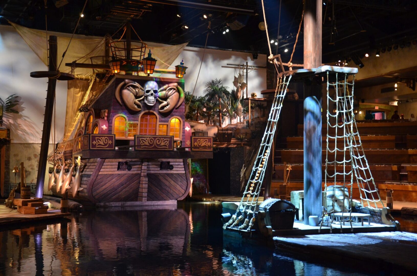 A theatrical stage with dramatic lighting and elaborate set pieces.