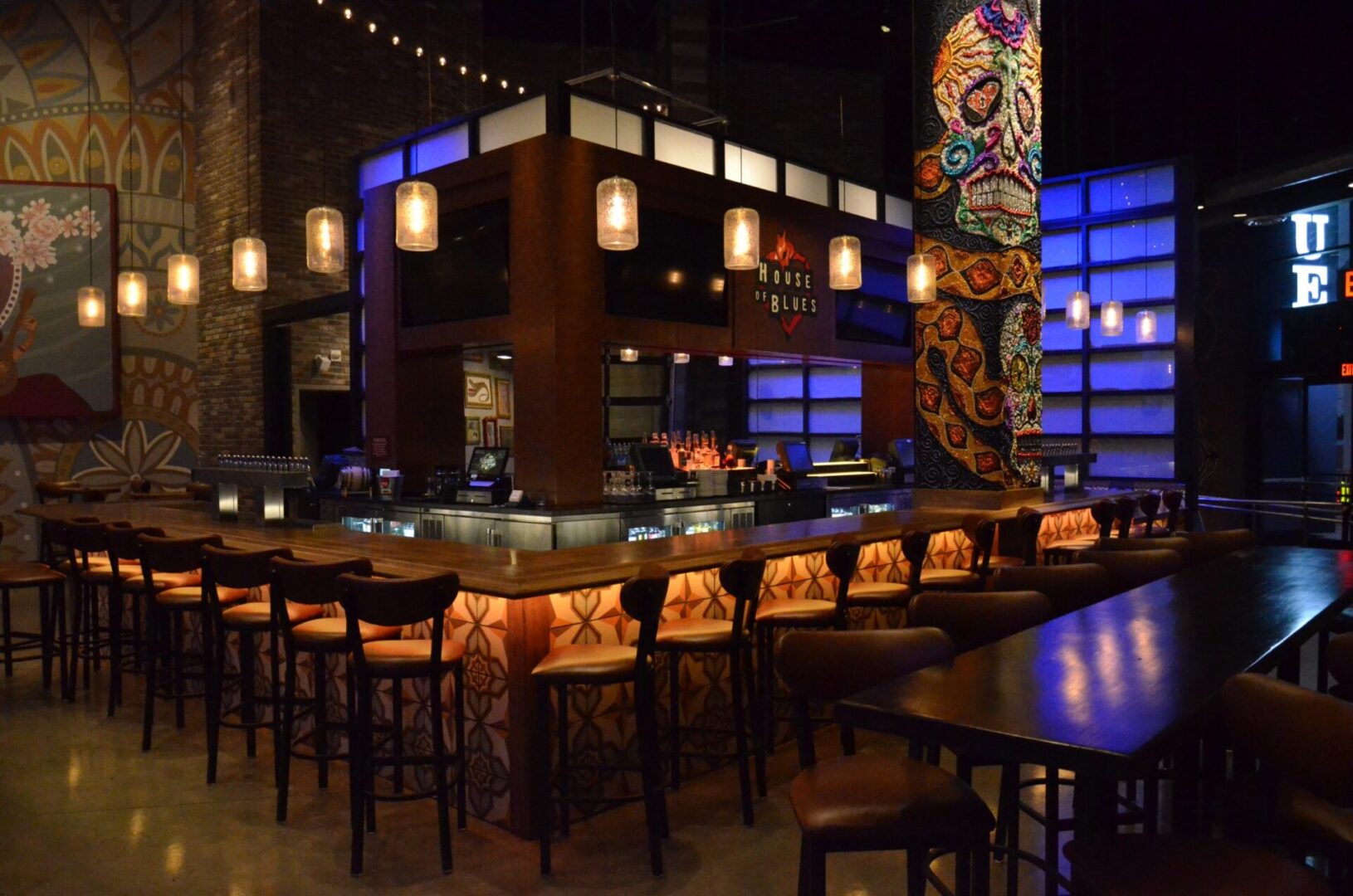 Stylish bar area with illuminated seating and decorative lighting.