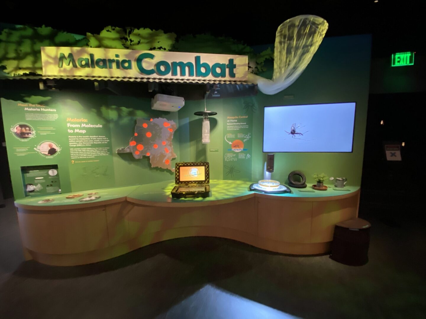 Interactive exhibit titled 'Valeria Combat' with a digital screen and control device.