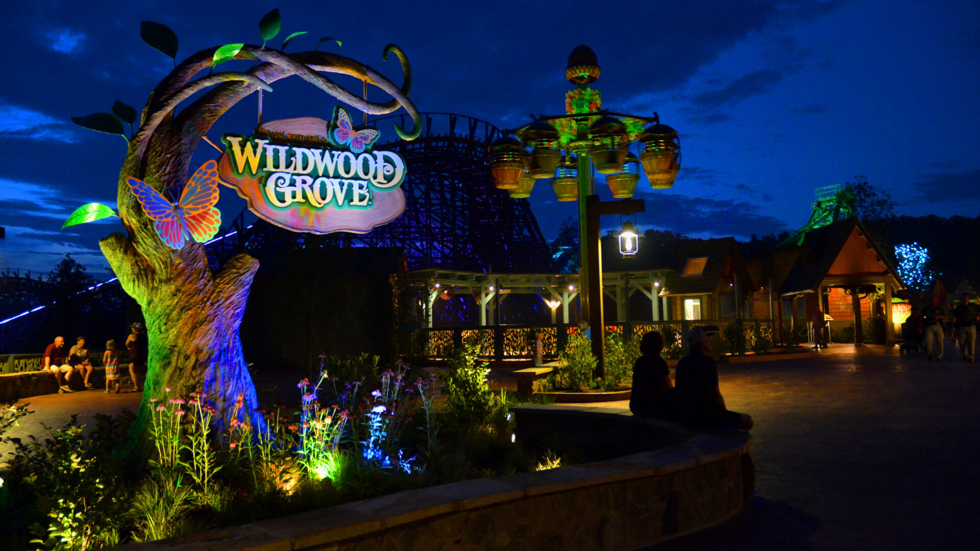 Colorful entrance sign to Wildwood Grove at night.