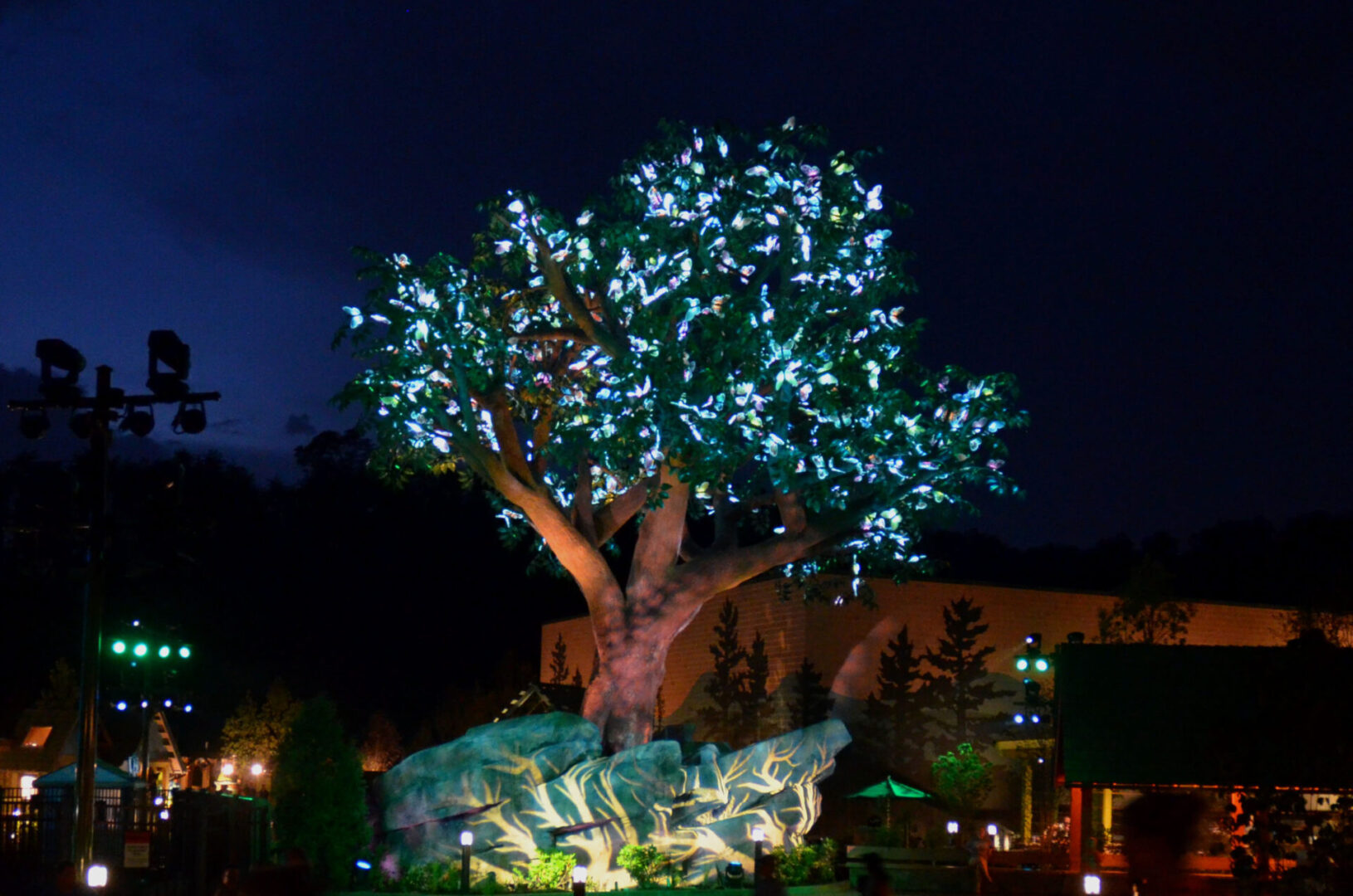 A tree adorned with glowing blue lights at night.