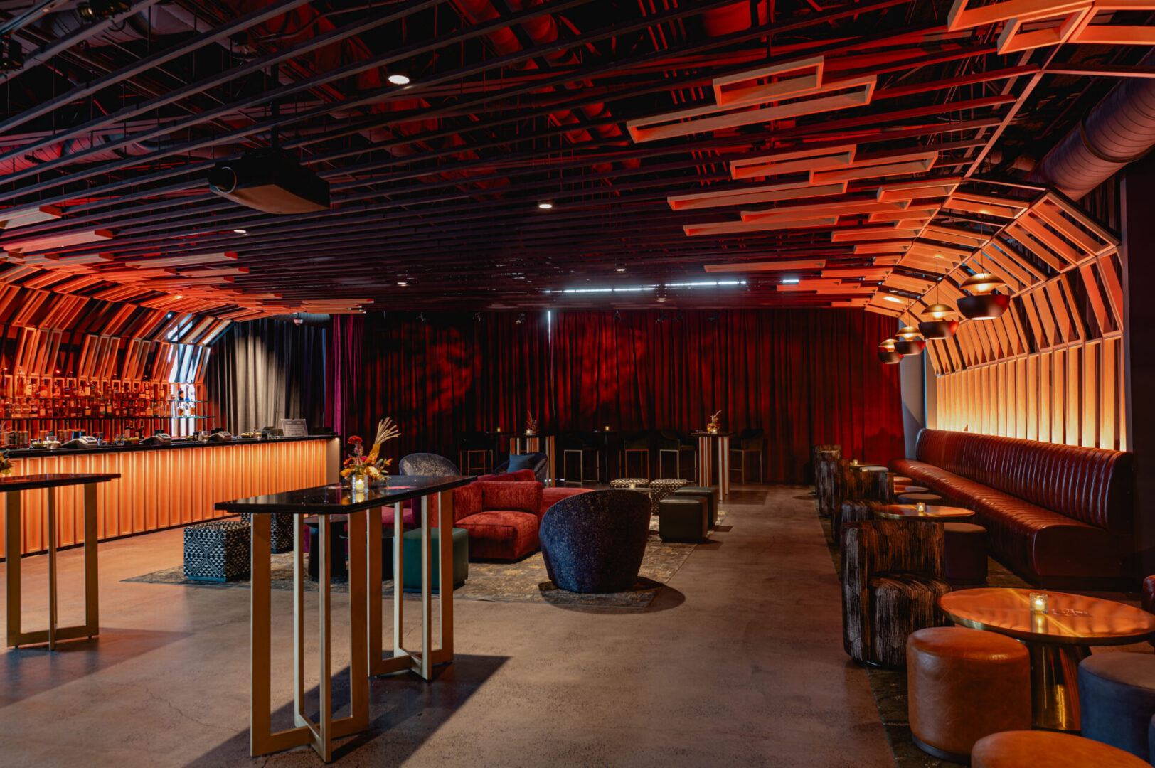 Stylish lounge with modern seating and dramatic lighting.