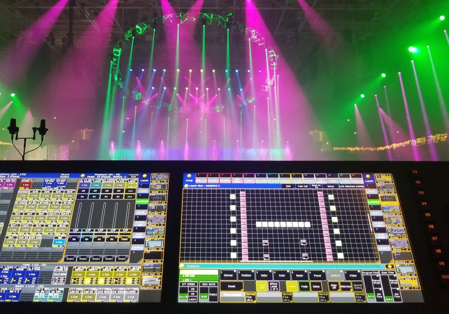 Lighting control system in a concert venue with colorful stage lights.