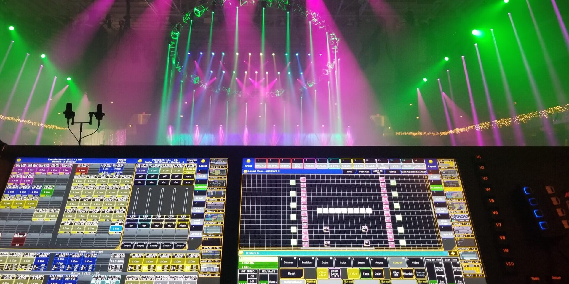 Lighting control system in a concert venue with colorful stage lights.