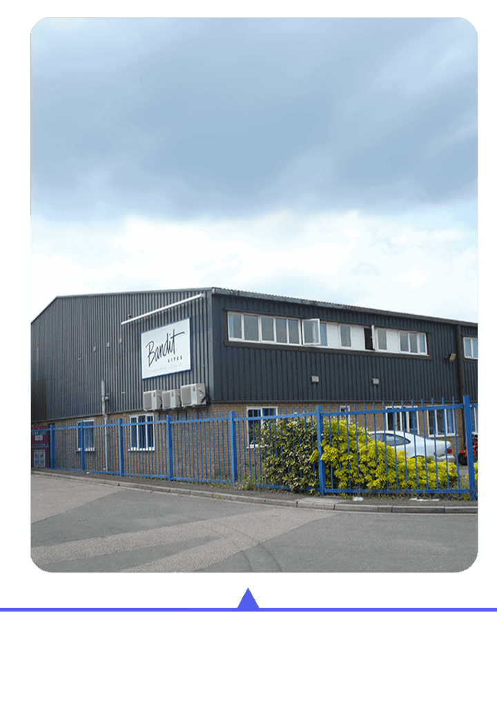 Modern industrial building with a fenced perimeter and clear signage.