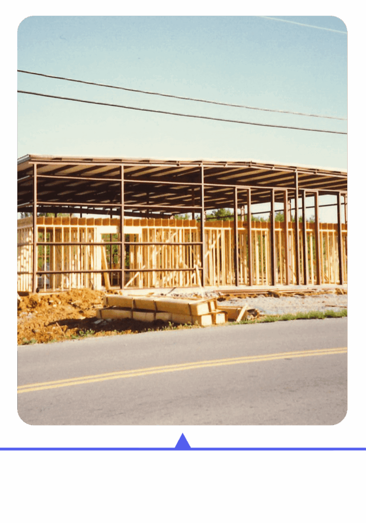 Construction site with wooden framing of a building in progress.