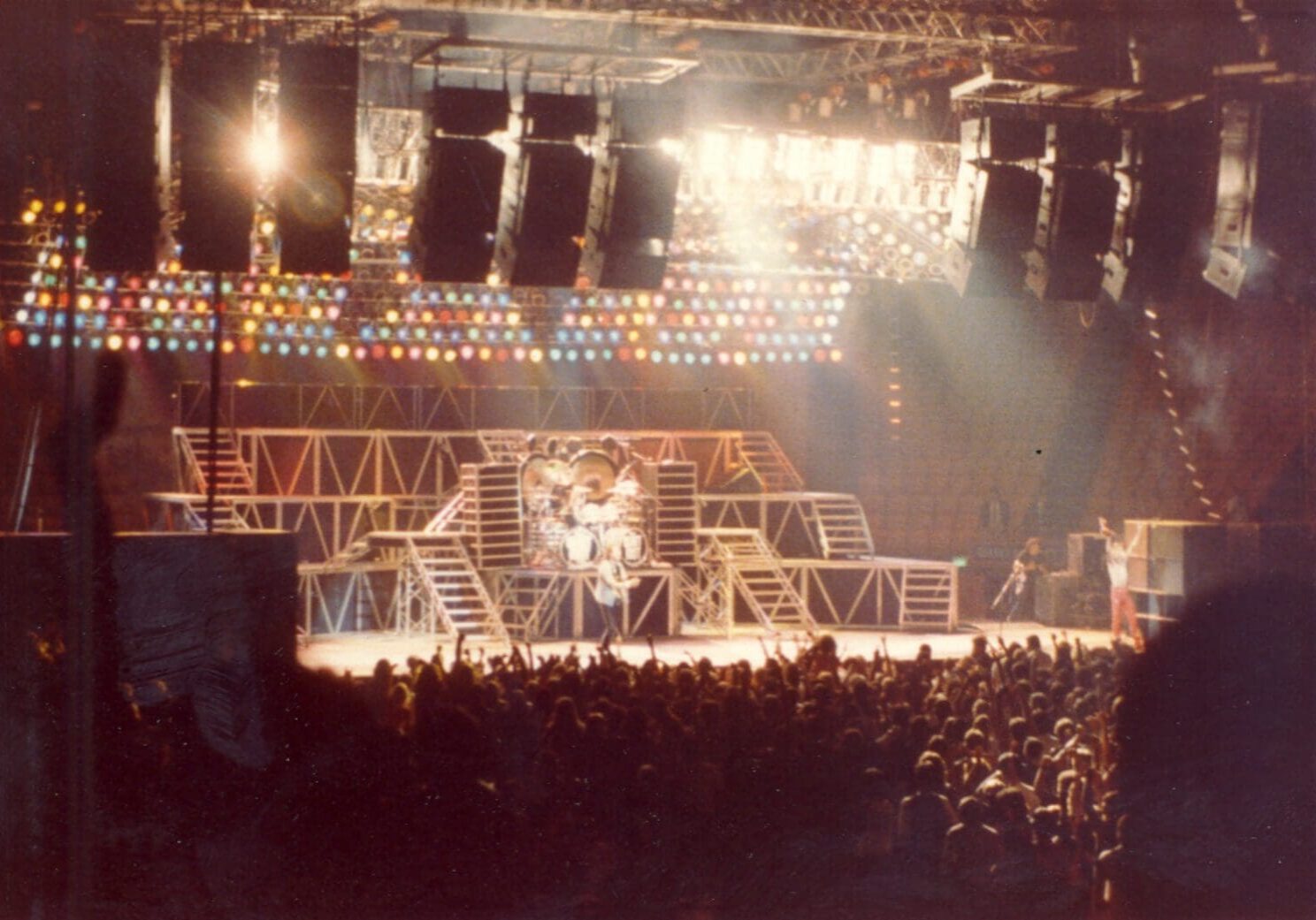 A live concert with bright stage lights and a large audience.